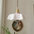 Medieval-style brass and cream glass chandelier light fitting with adjustable cord.