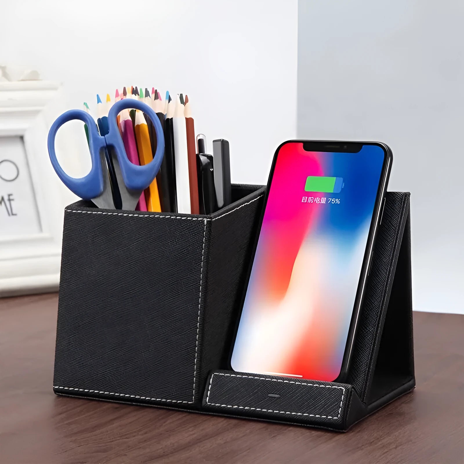 Black leather desk organiser with wireless phone charging surface and pen holder compartment