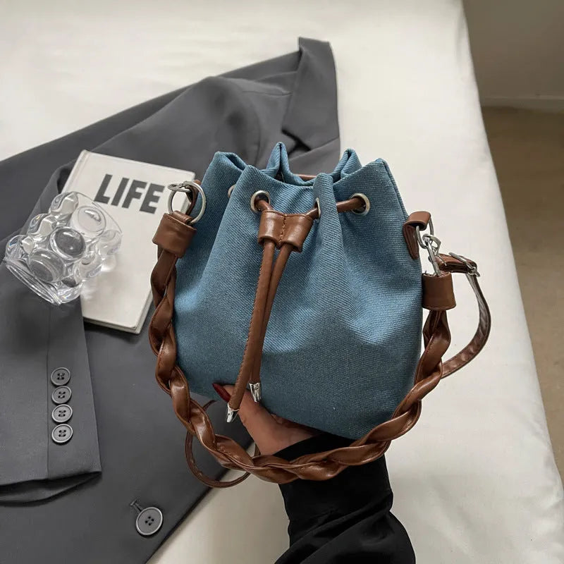 Blue one-shoulder cross body bucket bag with synthetic leather lining and sandwich pockets