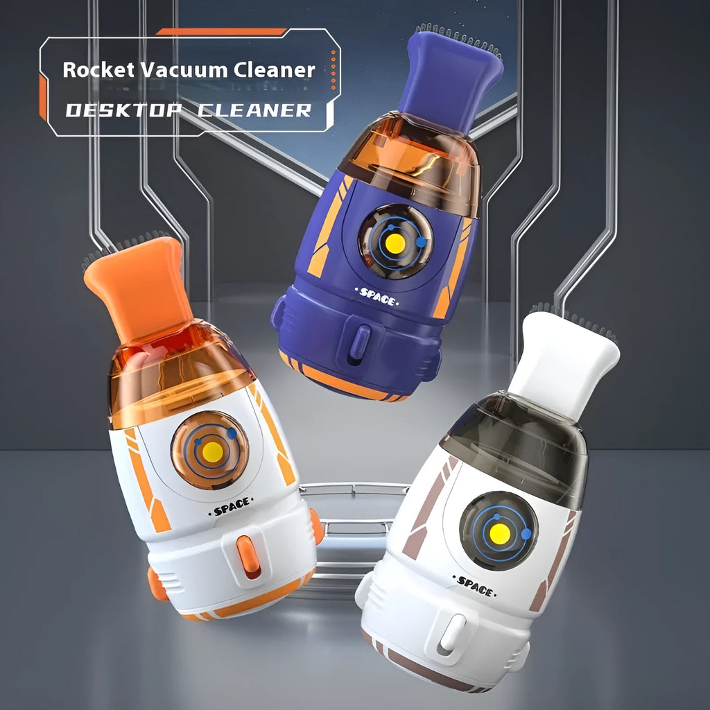 Handheld USB desktop vacuum cleaner in blue rocket design on a wooden desk next to a keyboard.
