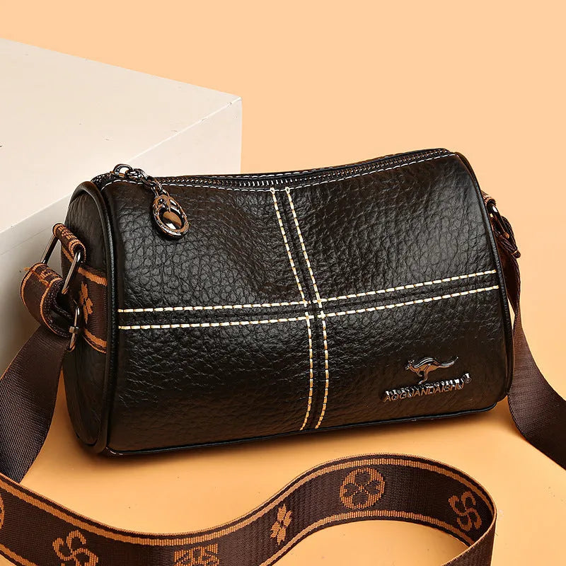 Casual genuine leather cylindrical shoulder bag for women in black, top grain, patchwork, soft texture.