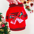 Red Christmas sweater for a small dog on a festive background, showing the 'Merry Christmas' print and pullover style.