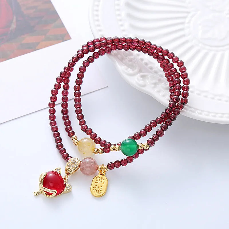 Purplish red garnet crystal fox charm bracelet with adjustable rope design