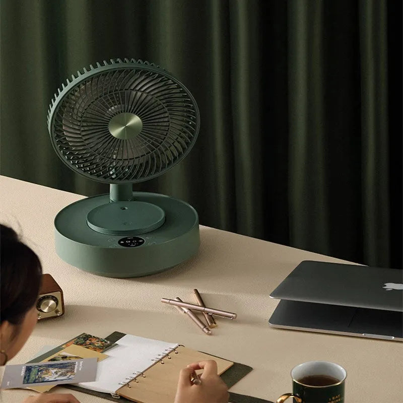 Green telescopic rechargeable electric fan showing extended floor-standing position with remote control