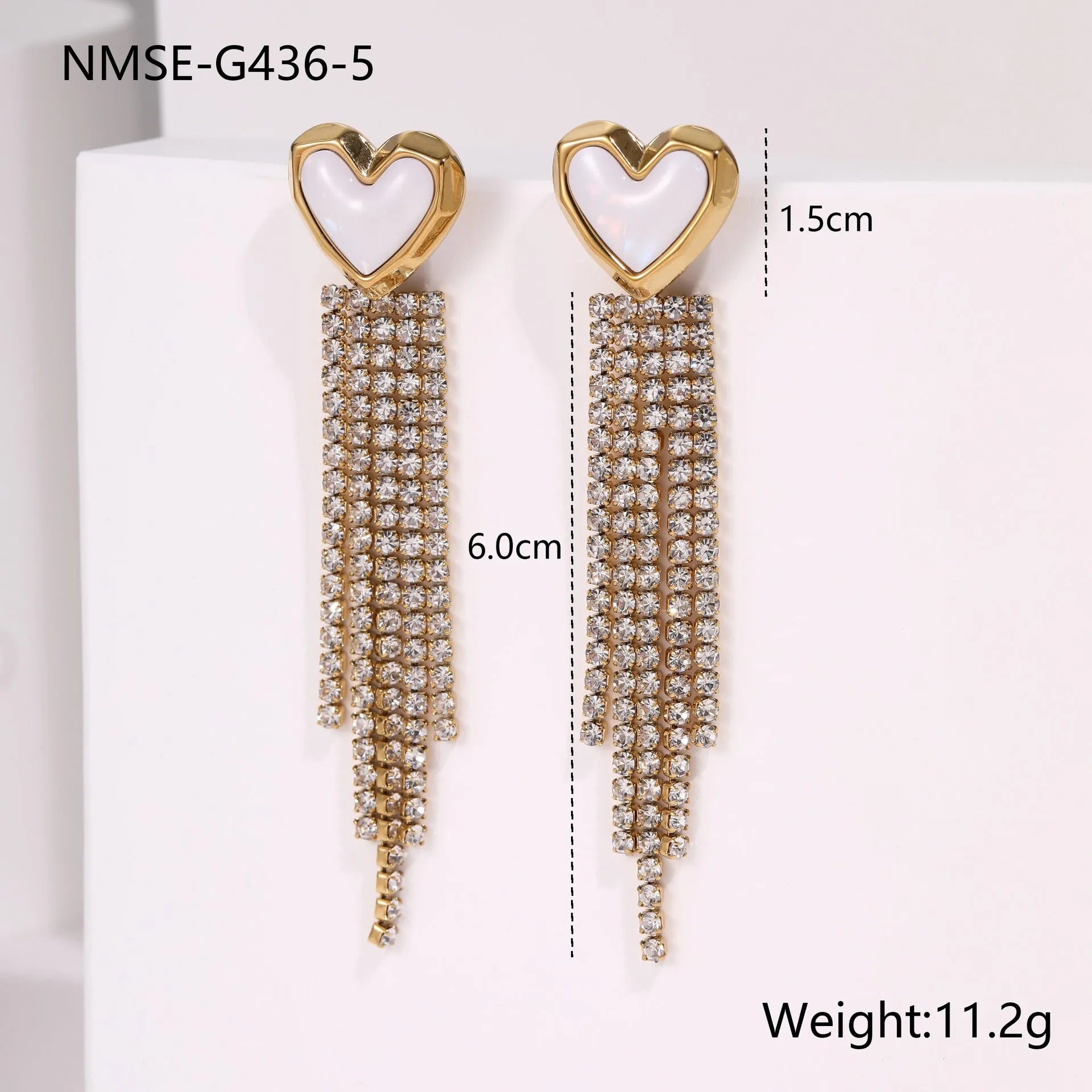 Gold-coloured stainless steel earrings with geometric heart, star, and tassel designs on a white background.