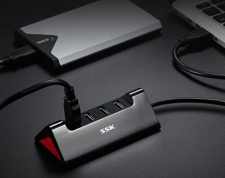 Black ABS plastic USB expansion dock with four ports and a Micro USB power connection.