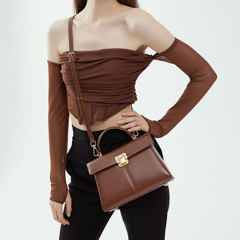 Genuine leather women's shoulder bag in horizontal square shape with adjustable strap.