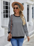 Black plaid pattern long sleeve polyester pullover sweater on a hanger.