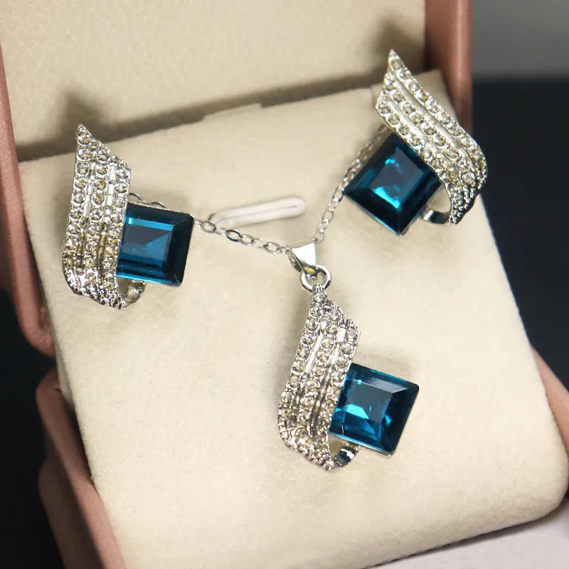 Necklace and earrings jewellery set with alloy pendant and glass details on cross chain