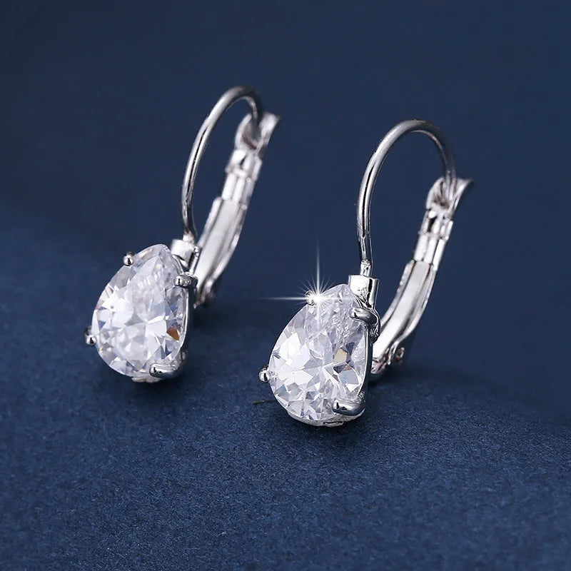 Women's drop-shaped copper earrings with gold finish and decorative platinum inlay.