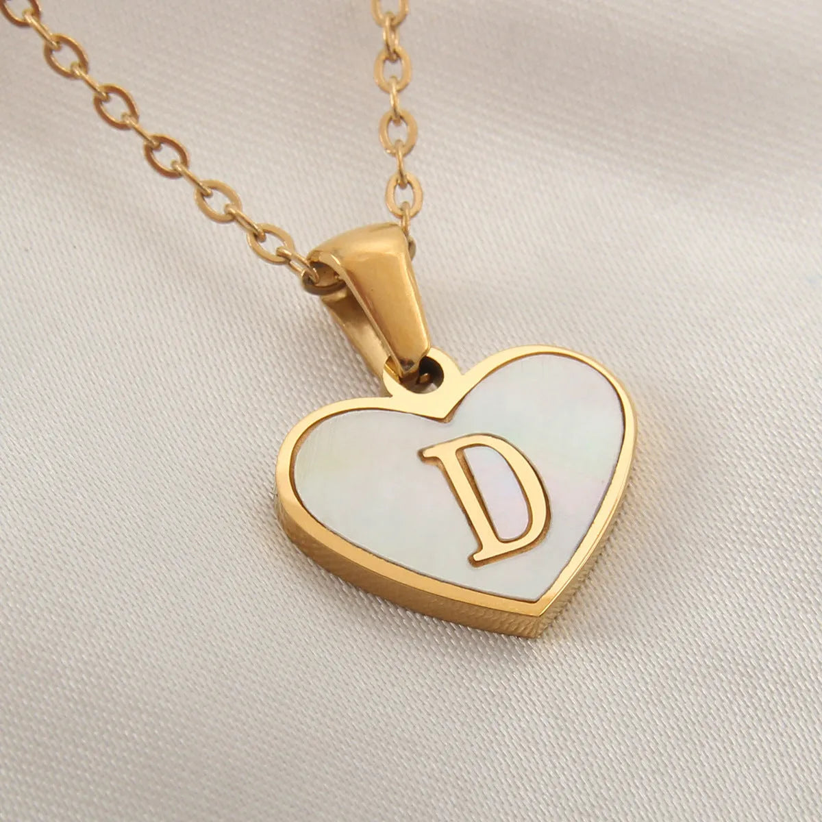 Gold plated heart necklace with white shell detail on an adjustable chain