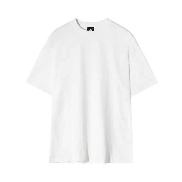 Man wearing a slim fit black cotton t-shirt with a round neck and regular sleeves.