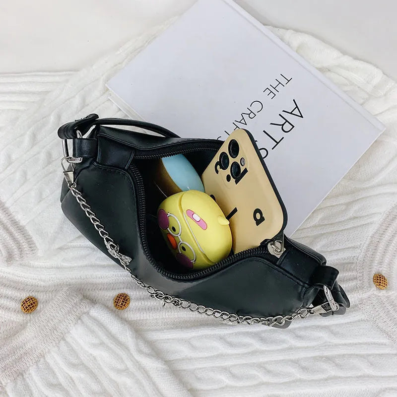 Butterfly chain underarm bag in black PU leather with crossbody strap and internal organisation pockets