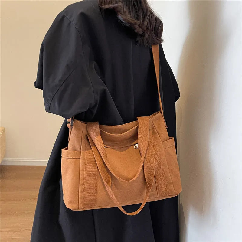 Large capacity polyester canvas shoulder bag in solid colour with sandwich pocket