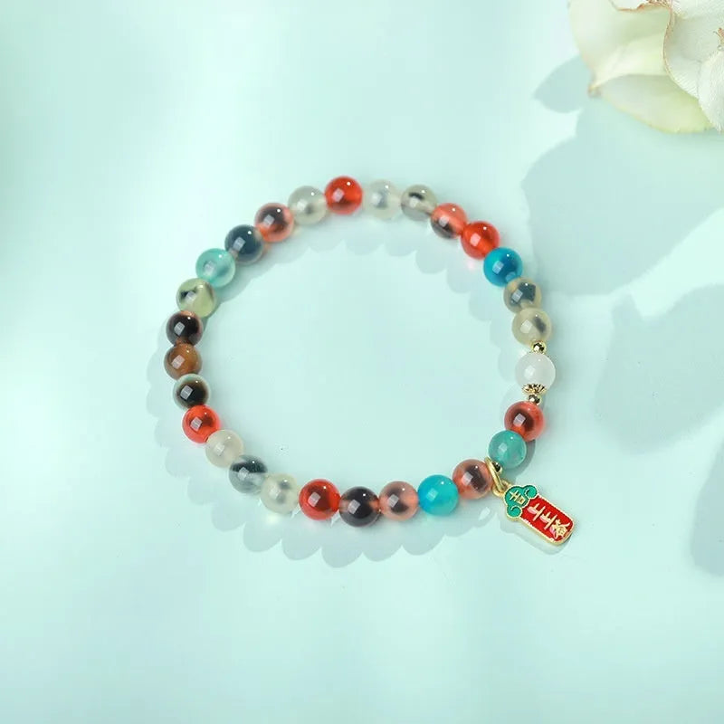 Women's agate bracelet with natural colourful sugar heart design and copper coin snake detailing