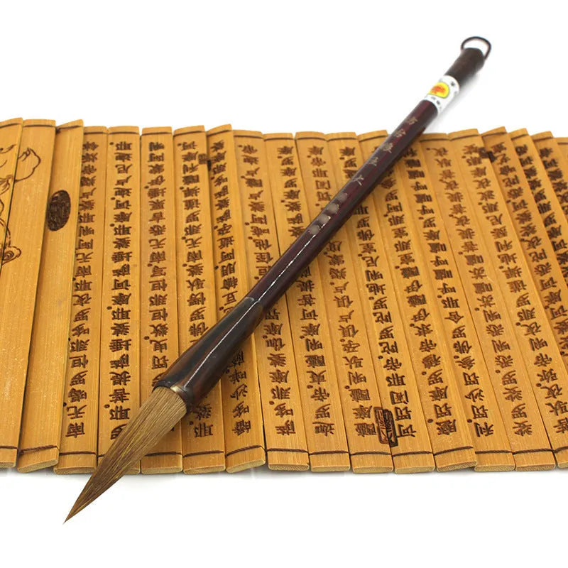 Traditional Chinese wolf hair calligraphy brushes with steel rod handles in large, medium, small, and trumpet sizes.
