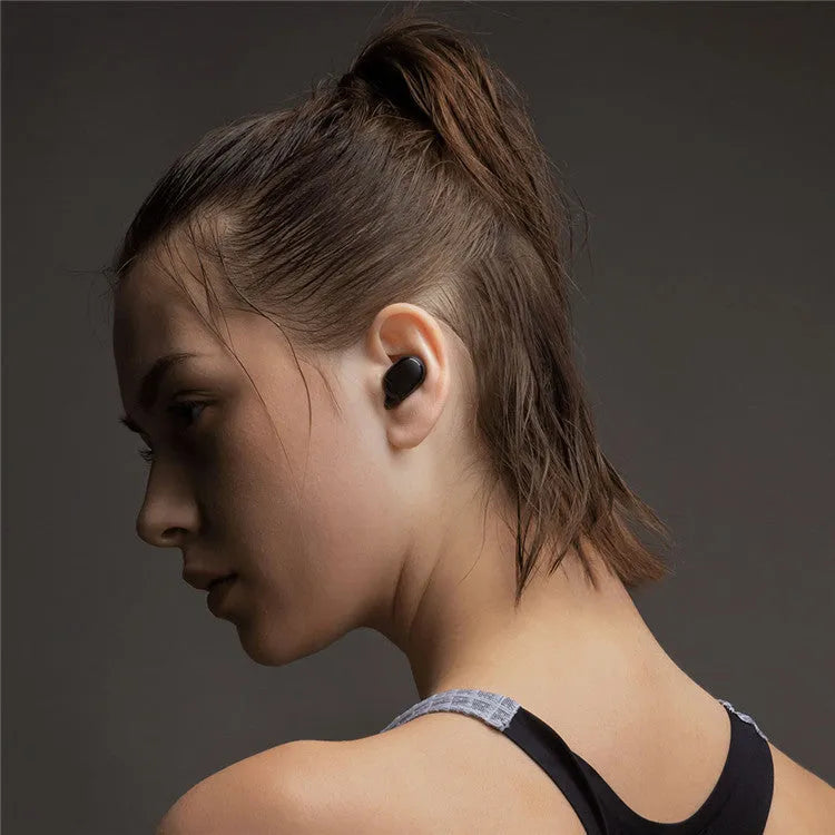 Black Redmi AirDots true wireless earbuds and charging case on a white background.