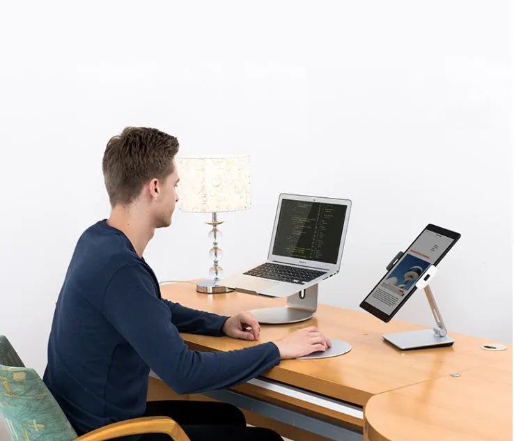 Black folding phone tablet holder with 360° rotating head on desktop