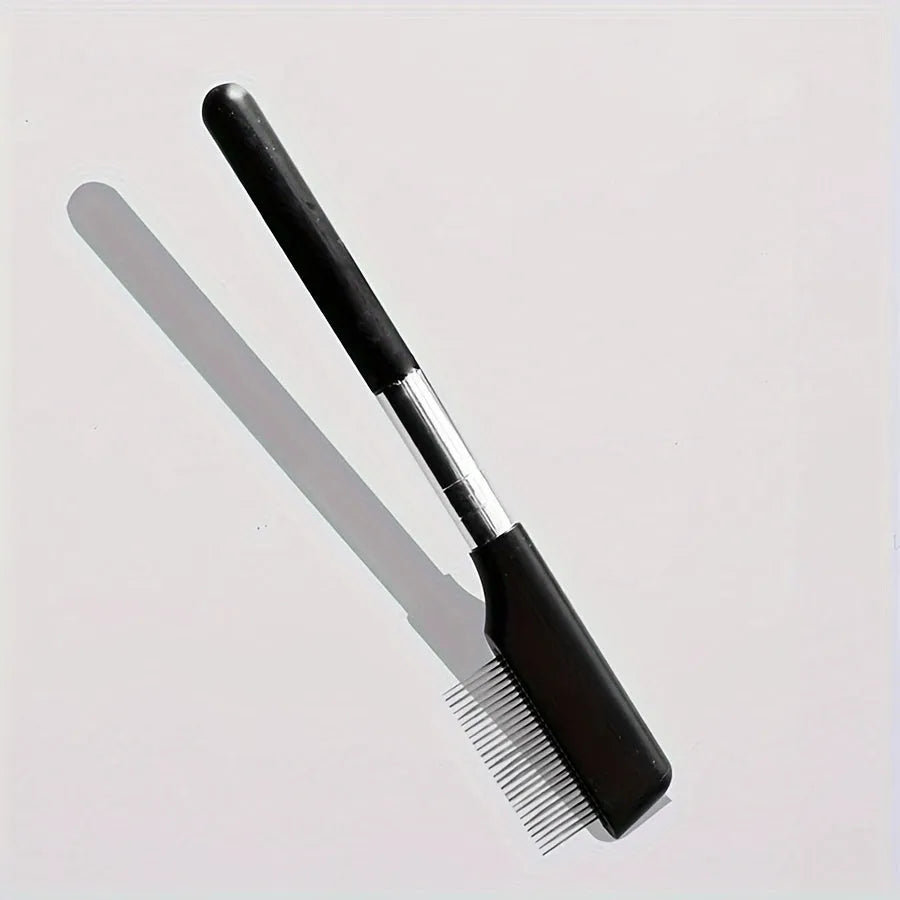 Black dual-ended pet grooming brush with soft silicone stain remover and plastic comb.