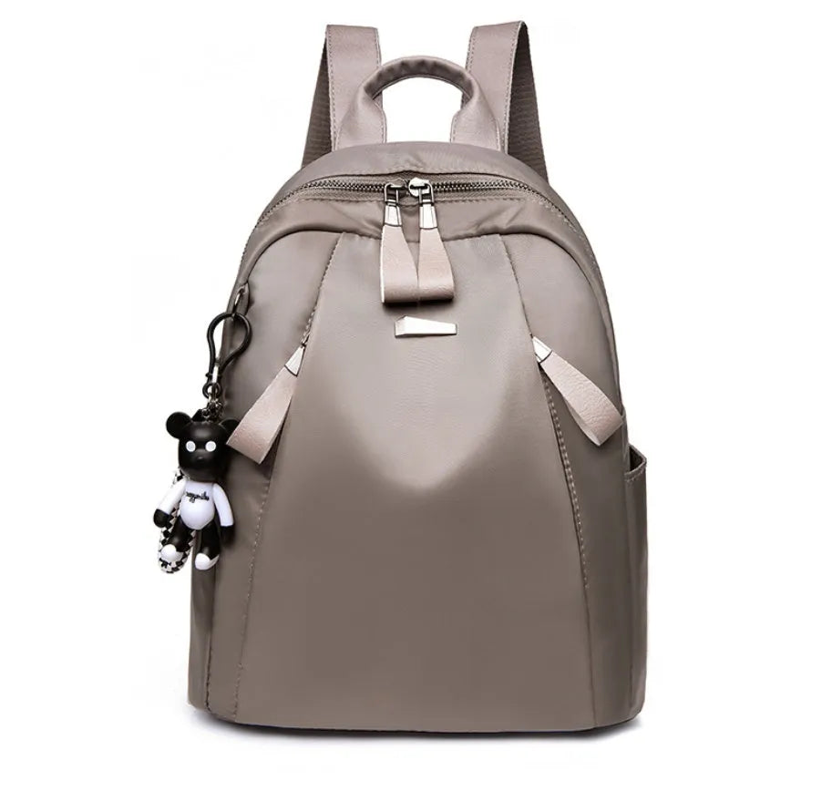 Medium-sized wine red Oxford cloth rucksack showing front view and internal organiser pockets.
