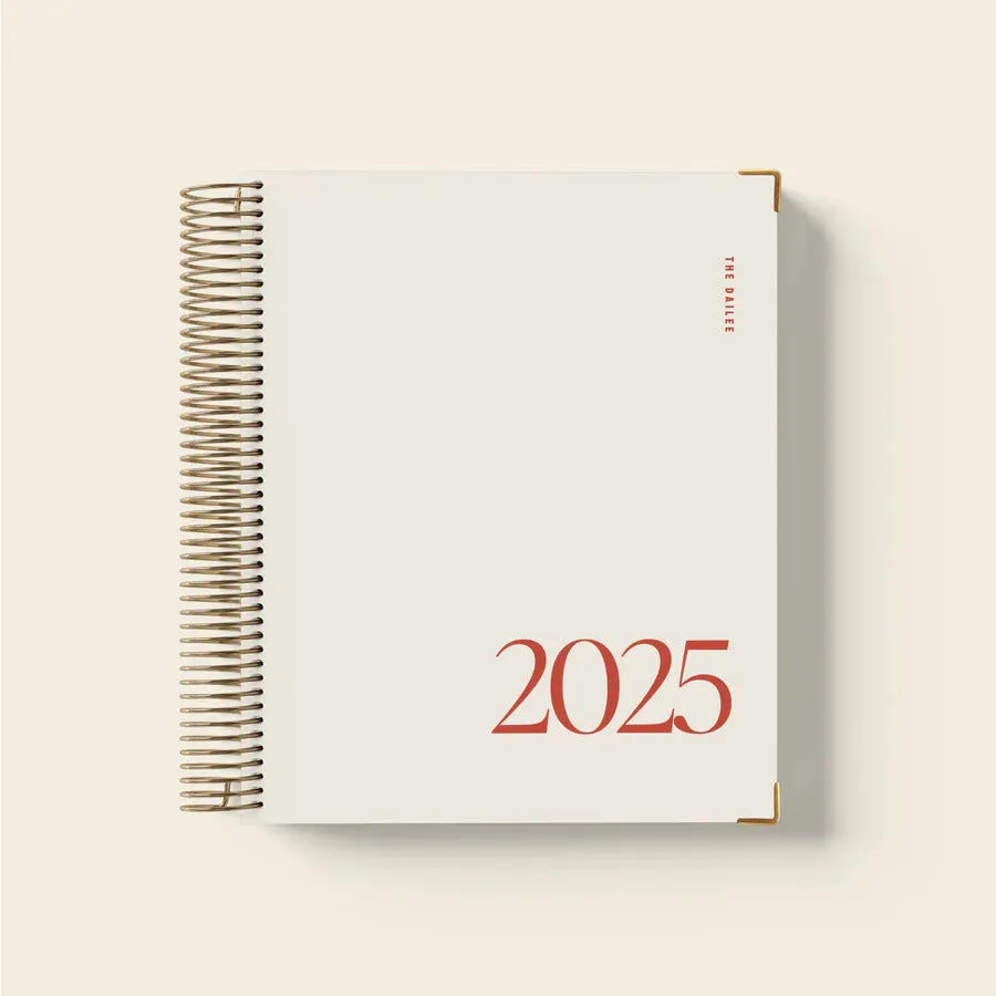 Cherry red coil notebook with spiral binding open to show flat-lying pages for writing