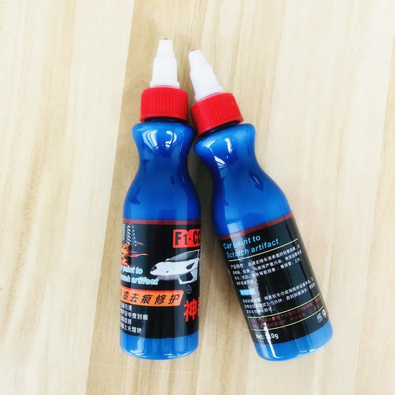 Small blue automotive scratch repair kit with repair agent bottle and applicator sponge for car paint damage