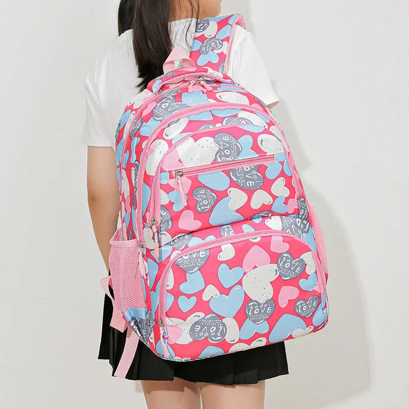 Blue children's Oxford cloth school backpack with large main compartment and padded air-pillow shoulder straps.