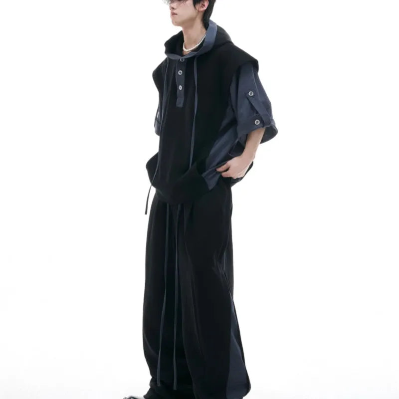 Man wearing a gray hooded short-sleeve sports jacket with 3D stitching and black matching trousers.