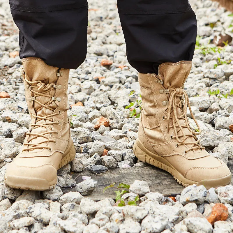 Yulong tactical desert combat boots in black and sand colour on a rocky outdoor terrain.