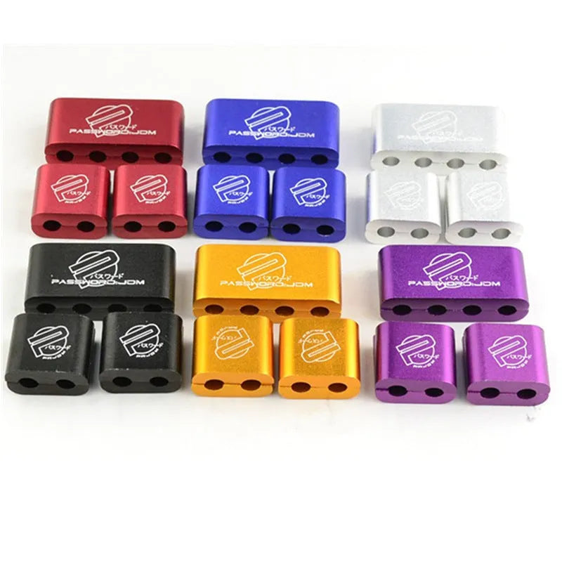 Three metal car fastening clamps in different colours for vehicle modification projects