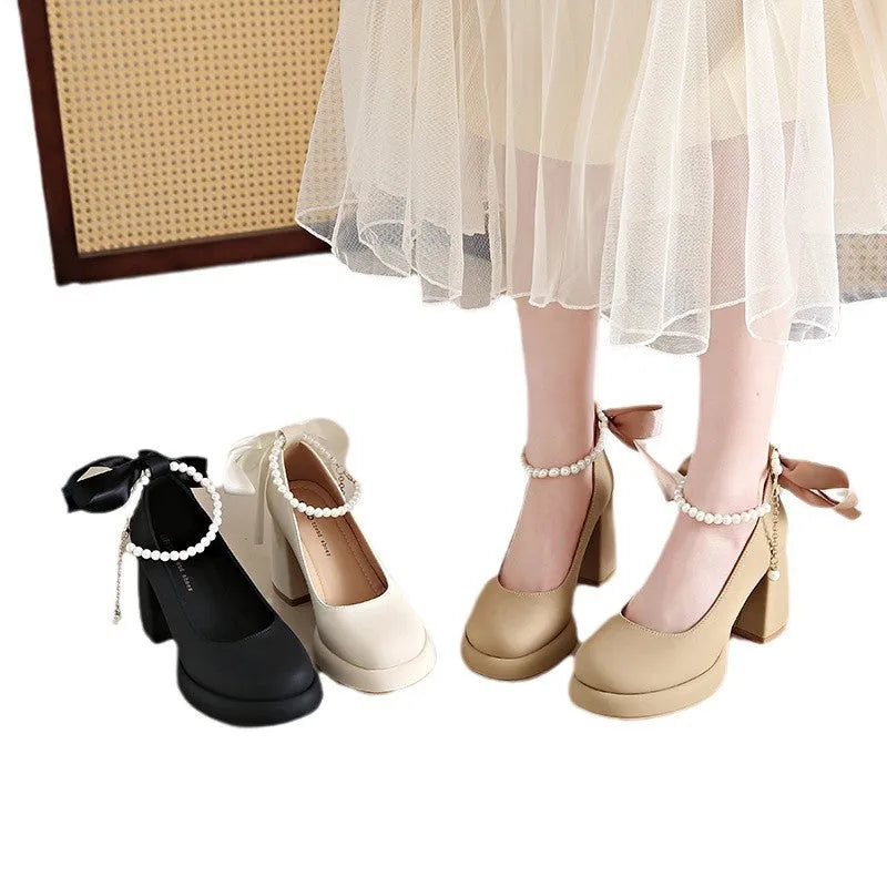 Beige women's Mary Jane shoes with a chunky heel and an ankle-strap buckle on a round toe.