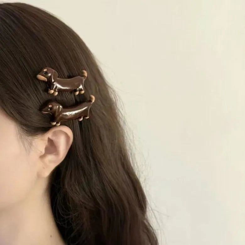Cute dachshund dog design hair barrettes with an electroplated metallic finish.