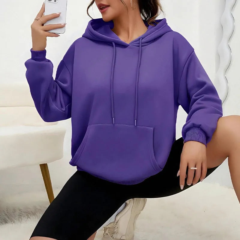 Women's loose grey drawstring pocket sweatshirt with long sleeves on a hanger.
