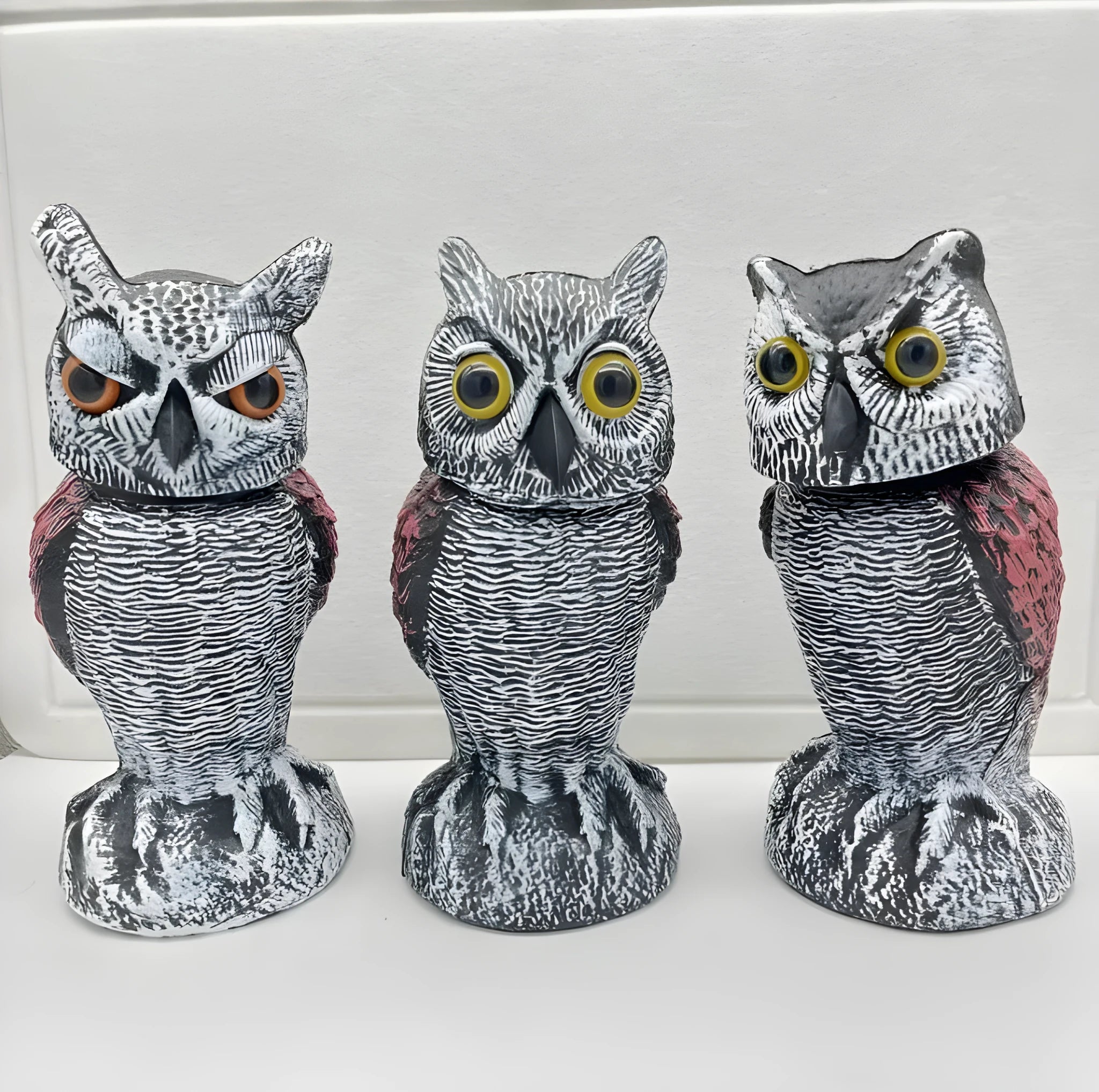 Artificial owl decoy with moving head for scaring birds, available with hook or bag attachments