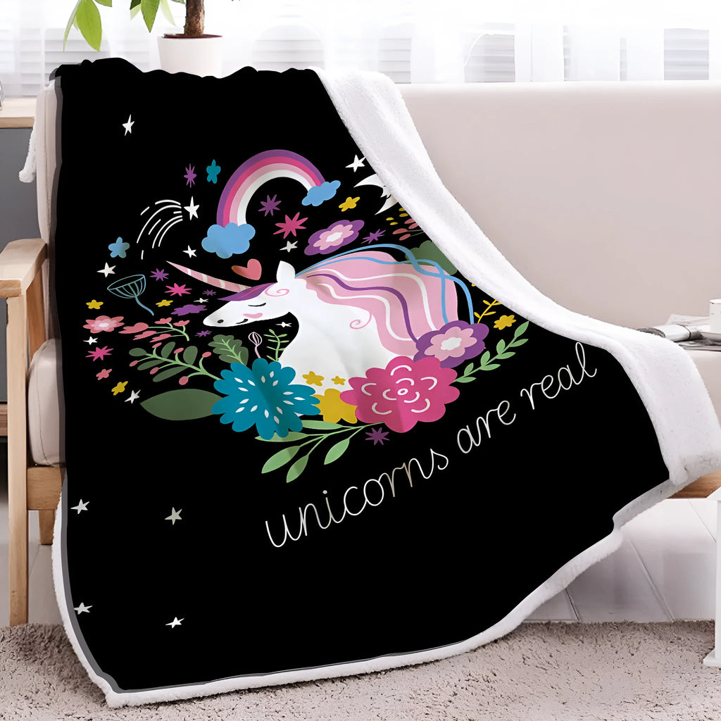 Black Sherpa fleece blanket with high weight, soft texture, and hemmed edges on a sofa
