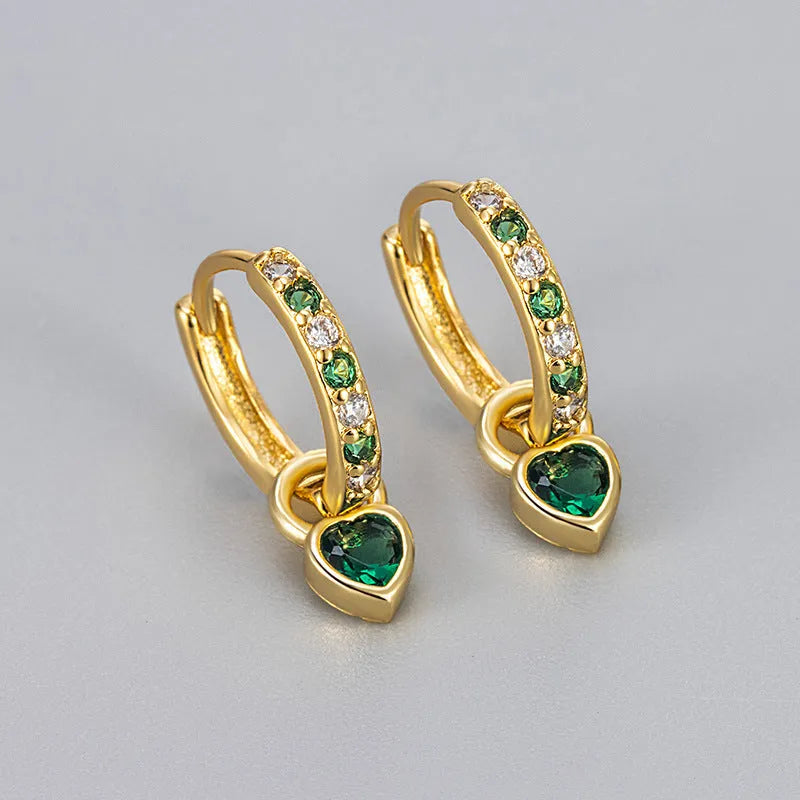 A pair of women's dangle earrings with a heart-shaped frame holding a coloured zircon stone.
