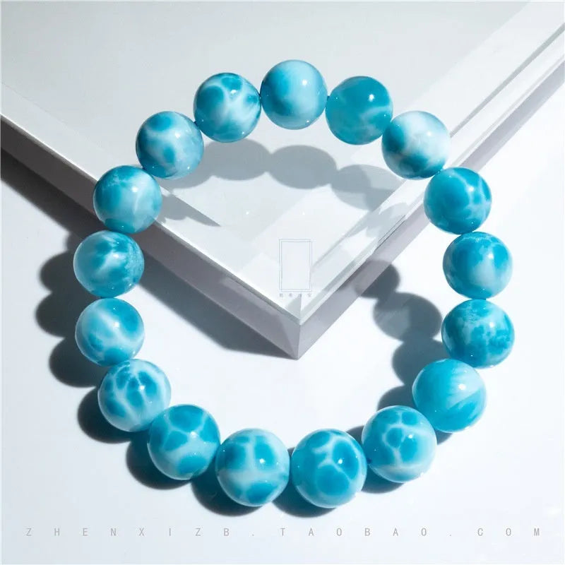 Blue and natural toned bodhi bracelet with a sea-pattern crystal stone centre and pearl accent.