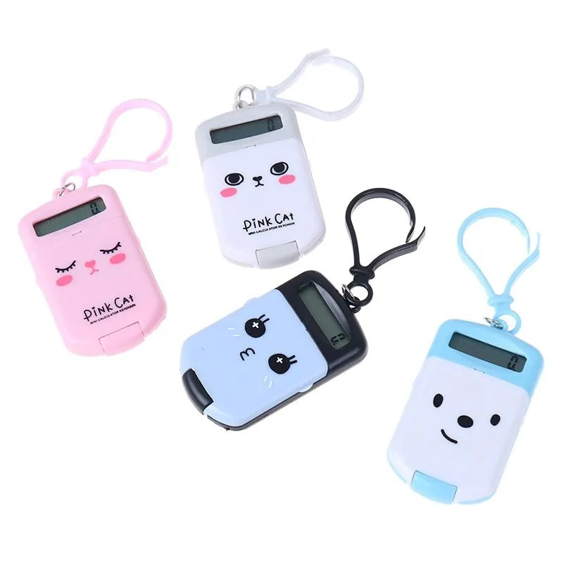 Creative cookie-shaped cute mini plastic calculator in black with key ring on a desk