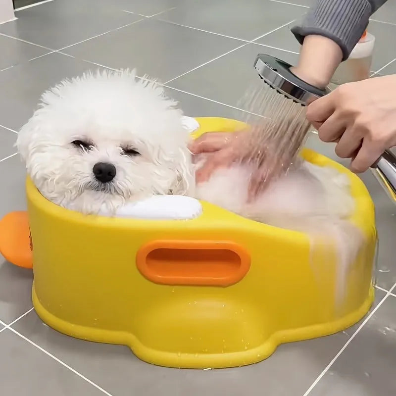Blue PVC bathtub shaped like a duck for washing dogs and cats, shown on a patio.
