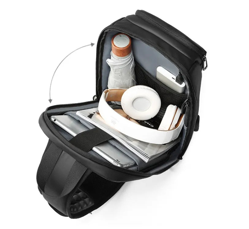 Black PVC outdoor shoulder bag with a square shape, showing the air cushion strap and front pocket.