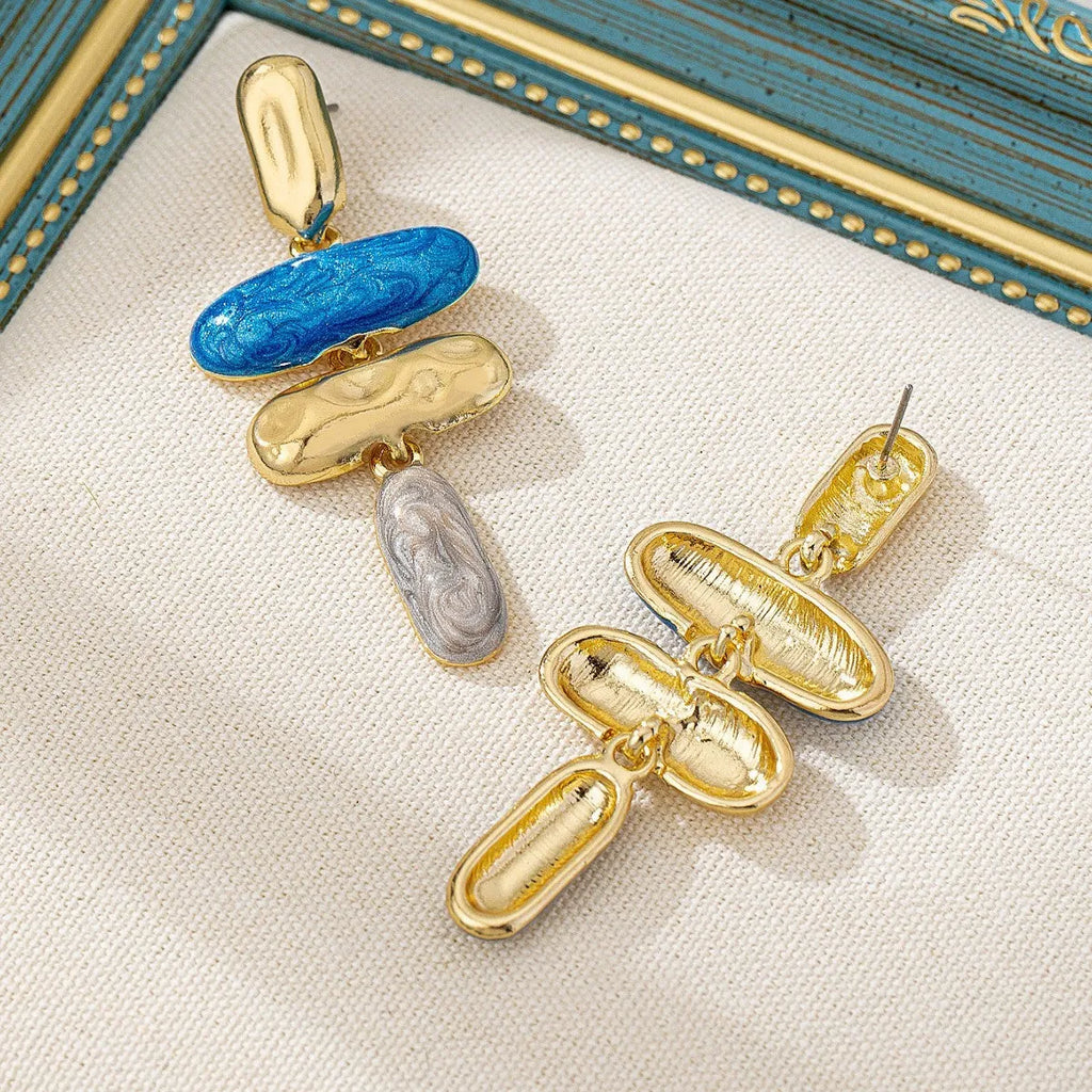 Gold-electroplated zinc alloy geometric stud earrings on a plain background.