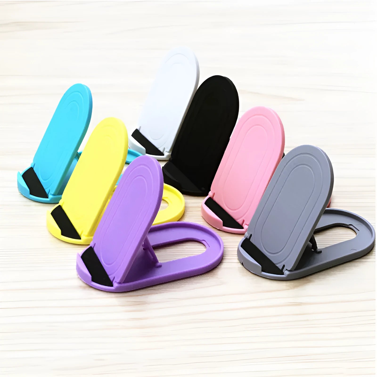 Plastic mobile phone stand with lazy bracket design in six colour options on white background