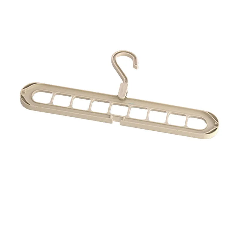 Green plastic hanger with nine holes for hanging multiple trousers or skirts vertically