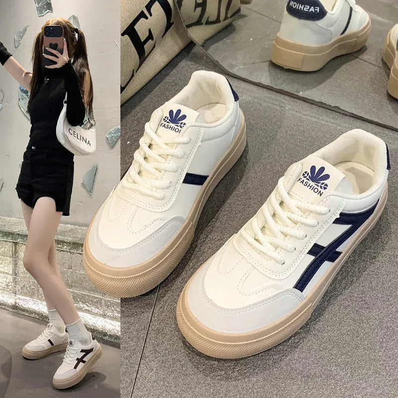 Classic brown and blue low-top casual trainers with flat rubber sole and lace-up front.