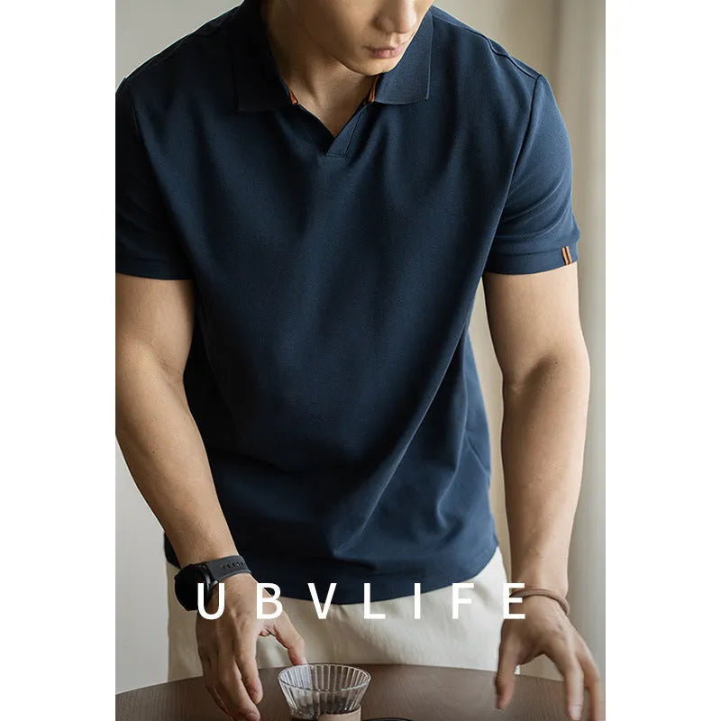 American-style light blue cotton blend short-sleeve polo shirt laid flat, showing regular fit and button placket.