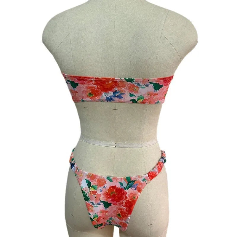 Women's floral print bikini set with lace trim on a tube top and briefs in blue.