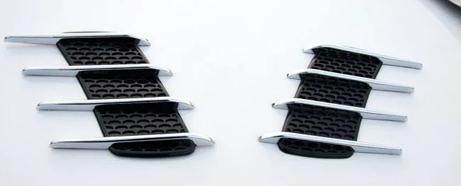 Black car body sticker with shark gill air outlet design and electroplated finish on a vehicle door