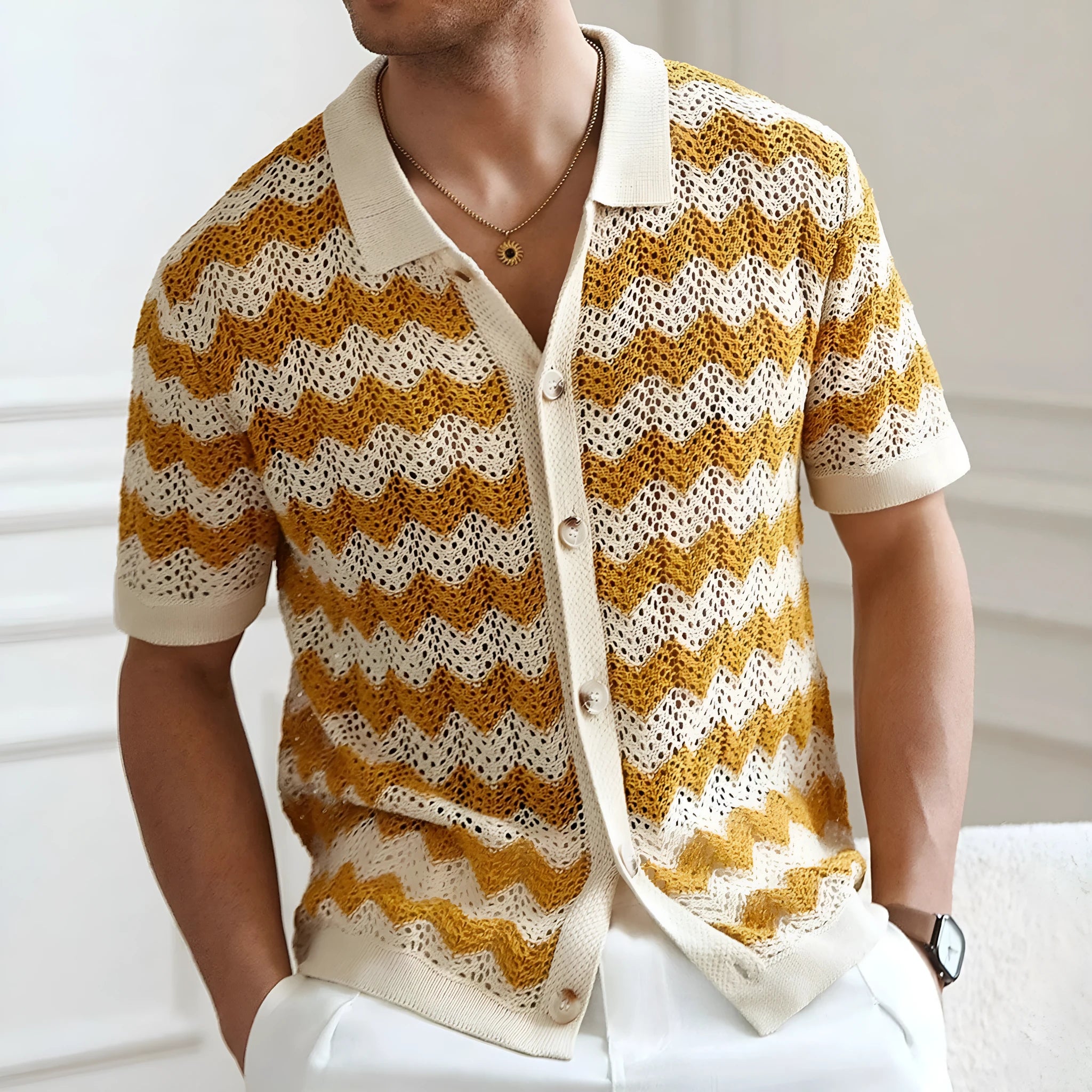 Yellow short-sleeve corduroy sweater with flocked jacquard pattern on a hanger.