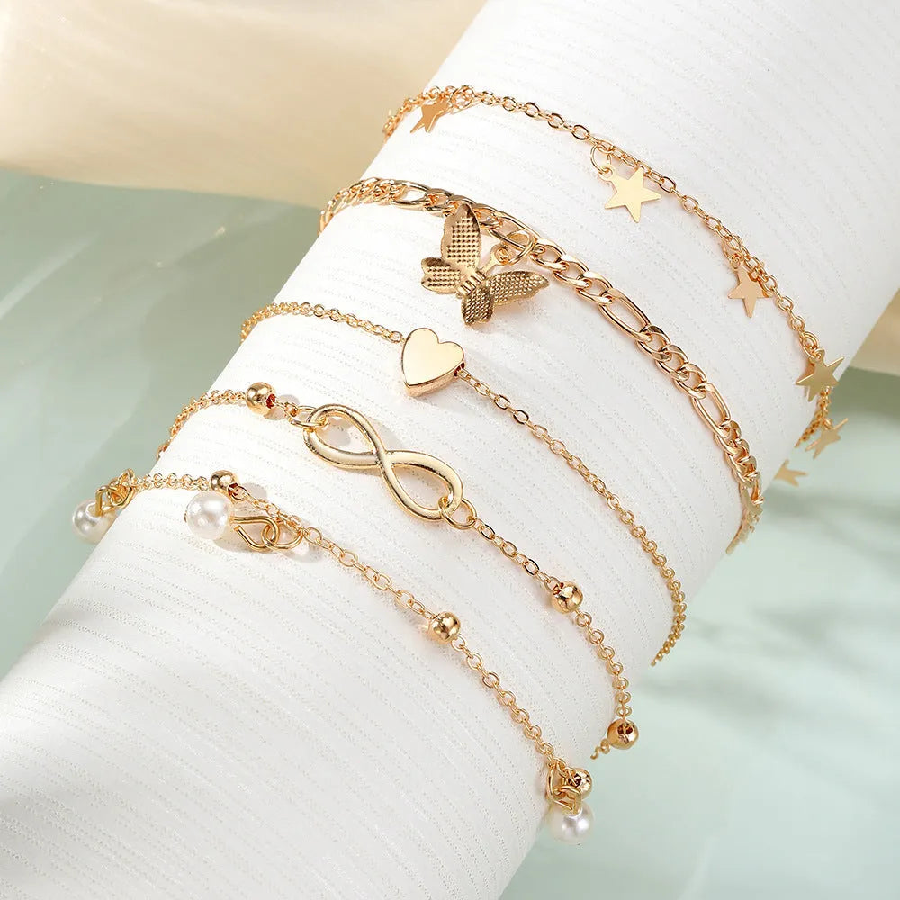 Butterfly Pearl Heart anklet 4-piece set showing layered women's ankle jewellery with charm details