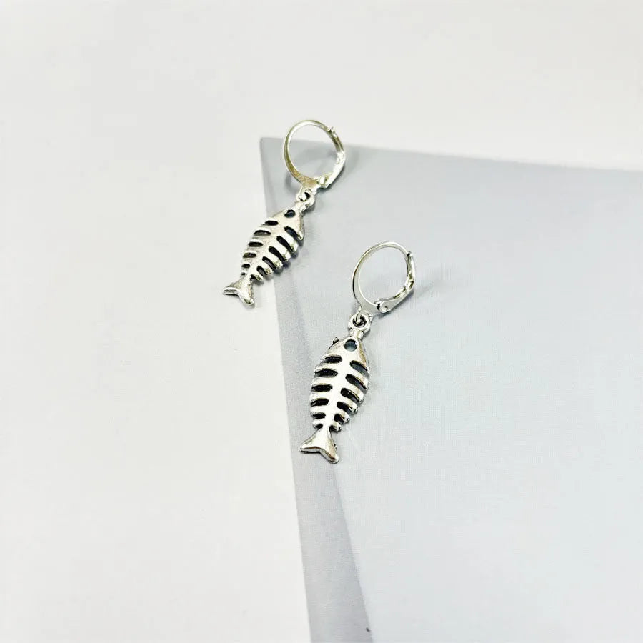 Fishbone pendant earrings and matching necklace set with adjustable chain on grey background